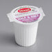 A white Hood Half & Half creamer cup with a purple label.