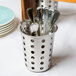A Vollrath metal container with spoons in it.