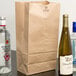 A Duro brown paper bag with bottles of alcohol inside.