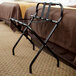 A black metal CSL luggage rack with black straps folded up.