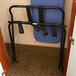 A CSL metal folding luggage rack with black straps.