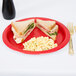 A Classic Red paper plate with a sandwich and macaroni on it.