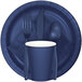 A navy blue Creative Converting paper plate with silverware and a blue cup on a white background.