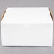 A plain white cardboard bakery box with a closed lid.