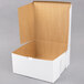 A white cardboard bakery box with an open lid, measuring 12 inches by 12 inches by 6 inches.