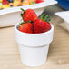 A white Tablecraft condiment bowl with strawberries in it.