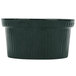 A hunter green cast aluminum souffle bowl with white specks.