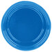 A blue cast aluminum souffle bowl with ridges on the rim.