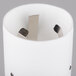 A white cylinder with metal rods inside.