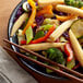A plate of vegetables with broccoli and whole baby corn on it with chopsticks.