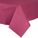 A burgundy tissue/poly table cover on a table.