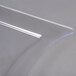 A clear plastic Fineline plate with a wavy edge.