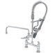 A chrome T&S mini pre-rinse faucet with club handles and a hose.