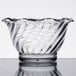A close-up of a clear Carlisle tulip dessert dish with a wavy design.