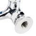A T&S chrome plated pet grooming faucet with a hose and nut.