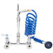 A T&S pet grooming faucet with a coiled blue hose.
