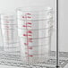 A stack of Cambro clear plastic round food storage containers.