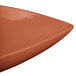 A Tablecraft copper triangle display bowl with a curved edge.