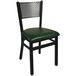 A black steel BFM Seating side chair with a green vinyl seat.