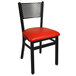 A black BFM Seating side chair with a red vinyl seat.