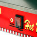 A close-up of a red and white Paragon Classic Dog hot dog machine with a switch.