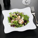 A salad with chicken and vegetables in a white GET Las Brisas melamine bowl.