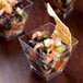 A group of Fineline clear plastic cube bowls filled with black bean and corn salsa.
