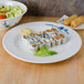 A Thunder Group Blue Bamboo melamine plate with sushi and salad on a table.