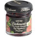 A jar of Dickinson's Pure Cascade Mountain Red Raspberry Preserves with a black lid.