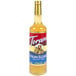 A Torani Italian Eggnog flavoring syrup 750 mL glass bottle with a label.
