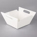 A white square porcelain bowl with handles.