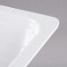 A close-up of a white GET Melamine food pan.