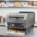 A Hatco TQ-1800 conveyor toaster with toasts in it.
