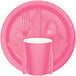 A Creative Converting candy pink paper plate with a fork, spoon, and knife.