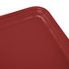 A red rectangular Cambro tray on a table.