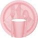 A close up of a pink Creative Converting paper plate with a fork and spoon.