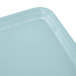 A rectangular sky blue Cambro tray with a black border and a small hole in the middle.