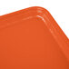 A rectangular citrus orange Cambro fiberglass tray on a table.
