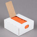 A white box with orange laminated twist ties inside.