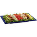 A Tablecraft blue speckled rectangular metal platter with salad toppings on it.