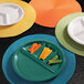 A white Elite Global Solutions melamine plate with four compartments filled with vegetables.
