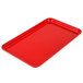 A red rectangular Cambro fiberglass tray on a counter.