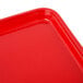 A red rectangular Cambro tray with a white corner spot.
