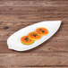 A white Elite Global Solutions melamine platter with papaya slices on it.