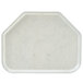 A white tray with a trapezoid shape and a small hole in the middle.