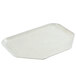 A white trapezoid-shaped Cambro tray with a hexagon pattern and silver trim.