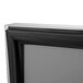 A close-up of a black and silver frame on a Turbo Air 1 door pizza prep table.