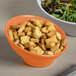 An Elite Global Solutions terracotta melamine bowl filled with salad and croutons.