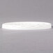 A Dinex translucent plastic lid on a white surface.