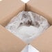A cardboard box with a plastic bag of white powder inside.